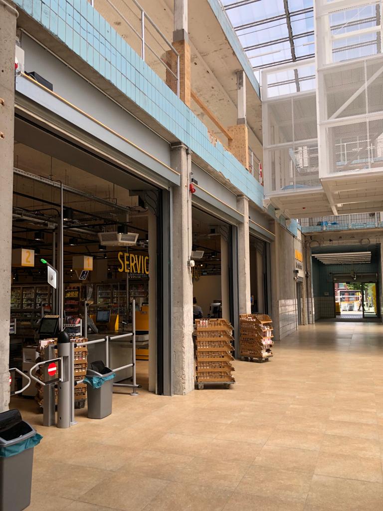Compact roller door as a partition wall for a shop at Melkhal Enschede